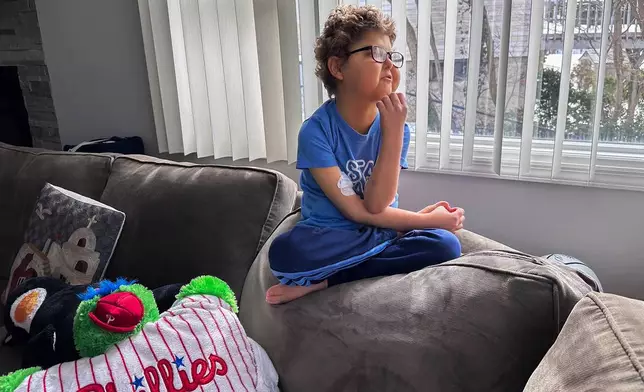 Logan Coyle, 9 years old, sits for a photo at his home, Tuesday, Feb. 10, 2026, in Port Washington, N.Y. (AP Photo/Phil Marcelo)