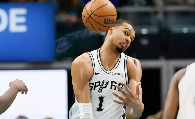 San Antonio Spurs forward Victor Wembanyama cannot grab a rebound during the first half of an NBA basketball game against the Detroit Pistons, Monday, Feb. 23, 2026, in Detroit. (AP Photo/Duane Burleson)