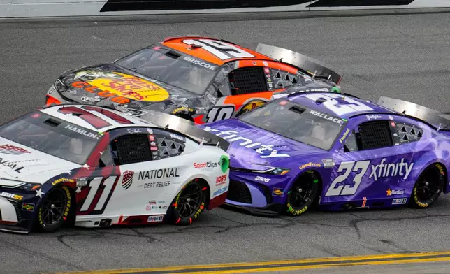Denny Hamlin, (11), Bubba Wallace, (23) and Chase Briscoe, (19) run during the NASCAR Daytona 500 auto race at Daytona International Speedway, Sunday, Feb. 15, 2026, in Daytona Beach, Fla. (AP Photo/Mike Stewart)