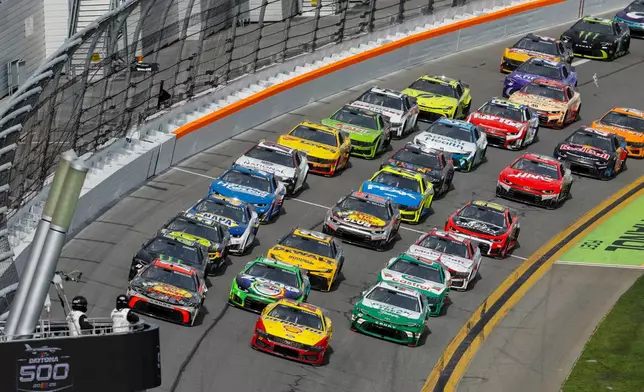 Cars move during the NASCAR Daytona 500 auto race at Daytona International Speedway, Sunday, Feb. 15, 2026, in Daytona Beach, Fla. (AP Photo/David Graham)