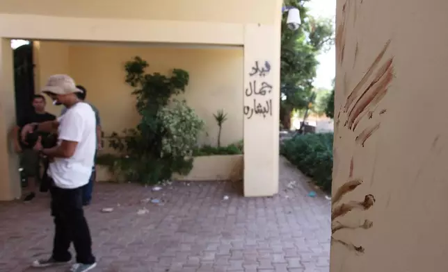 FILE - Bloodstains, believed to be from one of the American staff members of the U.S. Consulate, are seen Sept. 13, 2012, at the main gate after an attack that killed four Americans, including Ambassador Chris Stevens, on the night of Sept. 11, 2012, in Benghazi, Libya. (AP Photo/Mohammad Hannon, File)