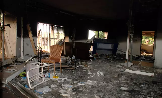 FILE - Glass, debris and overturned furniture are strewn inside a room in the gutted U.S. consulate in Benghazi, Libya, after an attack that killed four Americans, including Ambassador Chris Stevens., Sept. 12, 2012. (AP Photo/Ibrahim Alaguri, File)