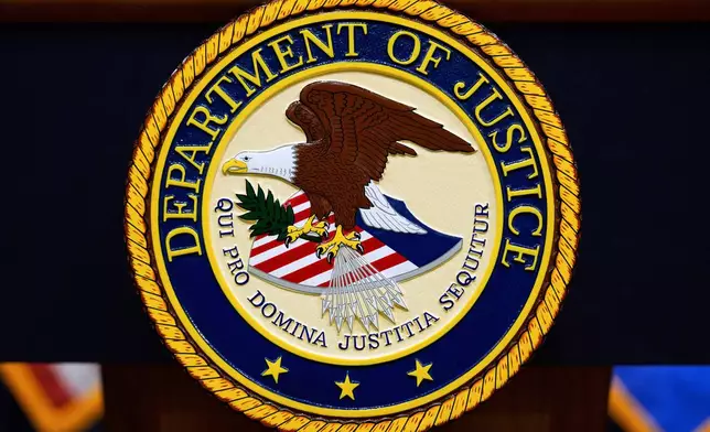 FILE - The U.S. Department of Justice logo is seen on a podium before a press conference, May 6, 2025, at the Justice Department in Washington. (AP Photo/Julia Demaree Nikhinson, File)