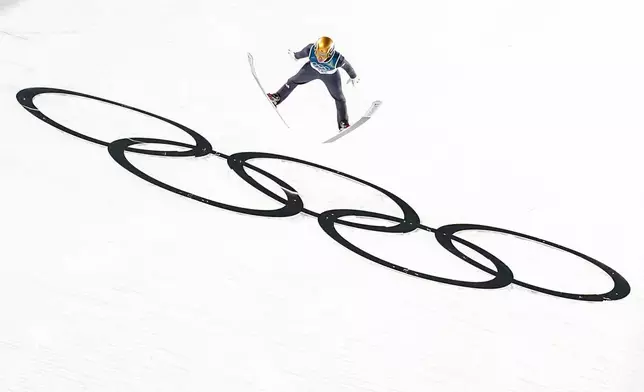 Philipp Raimund, of Germany, soars through the air during his final round jump in the ski jumping men's normal hill individual at the 2026 Winter Olympics, in Predazzo, Italy, Monday, Feb. 9, 2026. (AP Photo/Matthias Schrader)