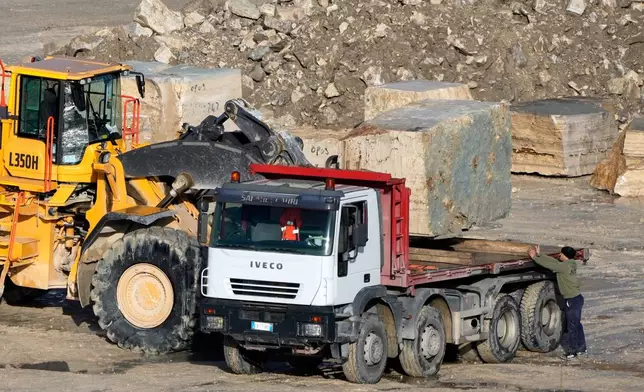 A wheel loader loads a block of travertine onto a truck at the Degemar Quarry near Tivoli, Italy, 35 kilometers east of Rome, on Friday, Feb. 13, 2026, where 17th-century Baroque architect Gian Lorenzo Bernini selected travertine for the colonnade of St. Peter's Square. (AP Photo/Gregorio Borgia)