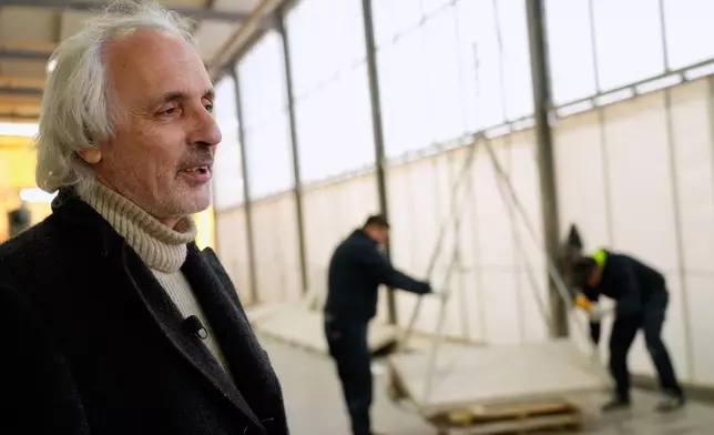 Fabrizio Mariotti is interviewed by The Associated Press at the Mariotti Carlo SpA stonecutting firm in Tivoli, Italy, on Friday, Feb. 13, 2026, as workers stack pieces of travertine that will be used to adorn the tower of the new Manhattan temple in New York City. (AP Photo/Gregorio Borgia)