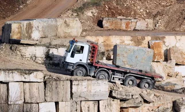 A truck carries a block of travertine at the Degemar Quarry near Tivoli, Italy, 35 kilometers east of Rome, on Friday, Feb. 13, 2026, where 17th-century Baroque architect Gian Lorenzo Bernini selected travertine for the colonnade of St. Peter's Square. (AP Photo/Gregorio Borgia)