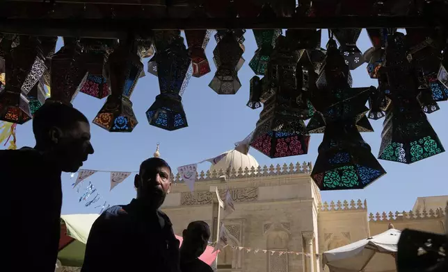 People buy traditional lanterns in Sayyeda Zeinab market ahead of the upcoming Muslim fasting month of Ramadan, in Cairo, Egypt, Tuesday, Feb. 17, 2026. (AP Photo/Amr Nabil)