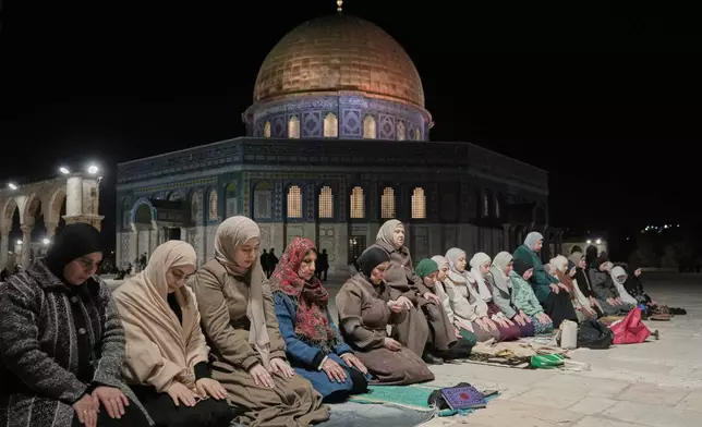 Muslim worshippers perform the evening Tarawih prayers during the holy fasting month of Ramadan, next to the Dome of Rock shrine at the Al-Aqsa Mosque compound in Jerusalem's Old City, Tuesday, Feb. 17, 2026. (AP Photo/Mahmoud Illean)