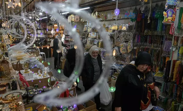 People shop for decorations in preparation for the upcoming Muslim holy month of Ramadan at a store in Beirut, Lebanon, Monday, Feb. 16, 2026. (AP Photo/Bilal Hussein)