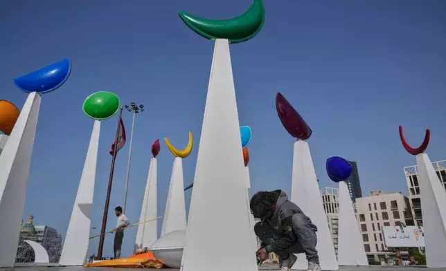 A worker sets decorations in preparation for the upcoming Muslim holy month of Ramadan, in downtown Beirut, Lebanon, Tuesday, Feb. 17, 2026. (AP Photo/Hussein Malla)