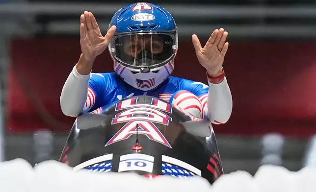United States' gold medalist Elana Meyers Taylor celebrates at the finish after the women's monobob competition at the 2026 Winter Olympics, in Cortina d'Ampezzo, Italy, Monday, Feb. 16, 2026.(AP Photo/Aijaz Rahi)