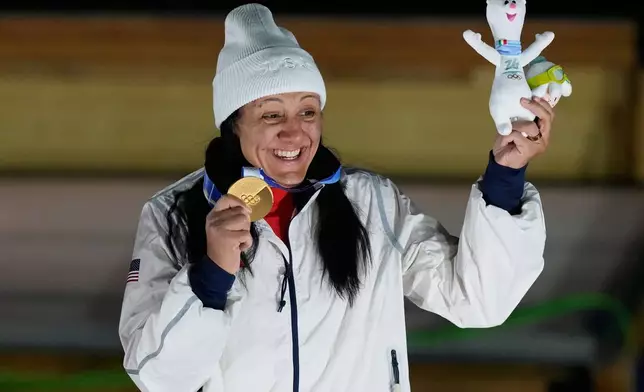 United States' gold medalist Elana Meyers Taylor poses on the podium after the women's monobob competition at the 2026 Winter Olympics, in Cortina d'Ampezzo, Italy, Monday, Feb. 16, 2026. (AP Photo/Aijaz Rahi)