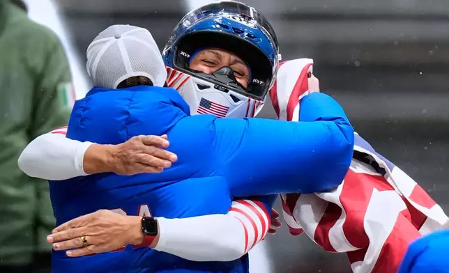 United States' gold medalist Elana Meyers Taylor celebrates at the finish after the women's monobob competition at the 2026 Winter Olympics, in Cortina d'Ampezzo, Italy, Monday, Feb. 16, 2026.(AP Photo/Aijaz Rahi)