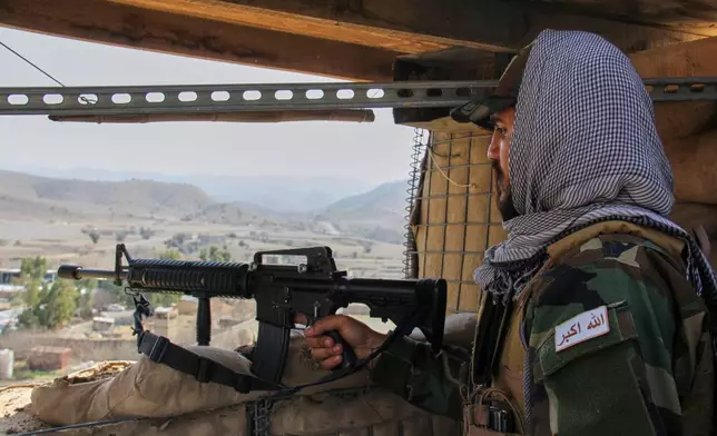 A Taliban soldier stands guard at a military checkpoint at the Afghan side of the Ghulam Khan crossing with Pakistan in Khost province, Afghanistan, Friday, Feb. 27, 2026. (AP Photo/Saifullah Zahir)