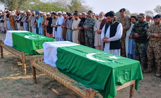 People offer funeral prayers for paramilitary soldiers killed during a gun-battle with militants in Waziristan area, on the outskirts of Kohat, Pakistan, Friday, Feb. 27, 2026. (AP Photo/S.B. Shah)