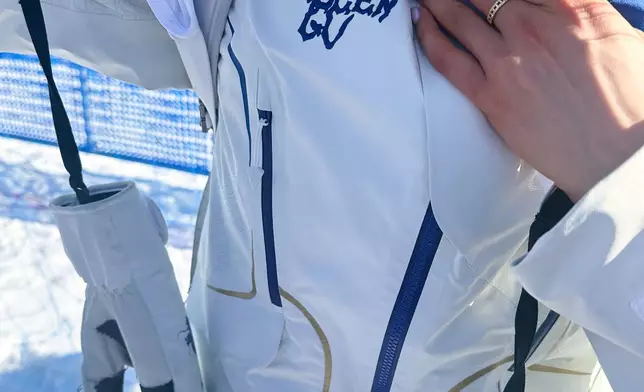 China's Eileen Gu shows her name on her ski suit after competing in women's freestyle skiing slopestyle qualifications at the 2026 Winter Olympics, in Livigno, Italy, Saturday, Feb. 7, 2026. (AP Photo/Eddie Pells)