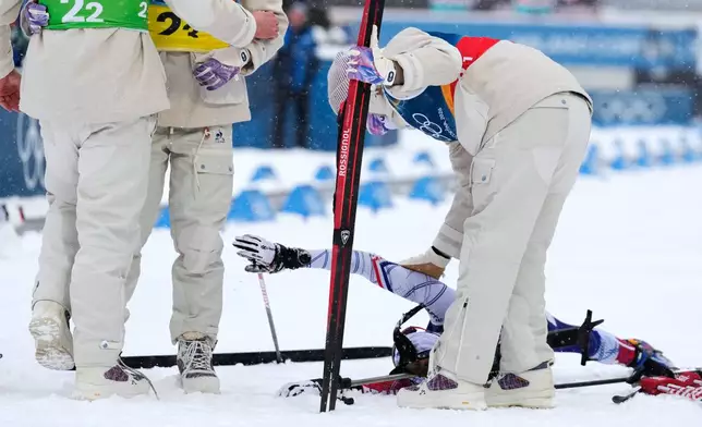 Eric Perrot, of France, reaches up in the finish area after winning gold in the men's 4x7.5-kilometer relay biathlon race at the 2026 Winter Olympics in Anterselva, Italy, Tuesday, Feb. 17, 2026. (AP Photo/Mosa'ab Elshamy)