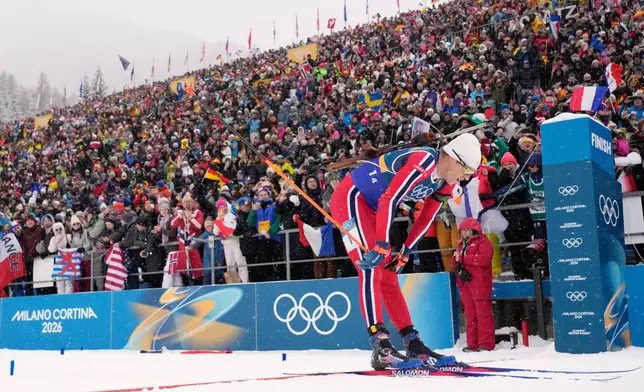 Vetle Sjaastad Christiansen, of Norway, crosses the finish line for silver in the men's 4x7.5-kilometer relay biathlon race at the 2026 Winter Olympics in Anterselva, Italy, Tuesday, Feb. 17, 2026. (AP Photo/David J. Phillip)