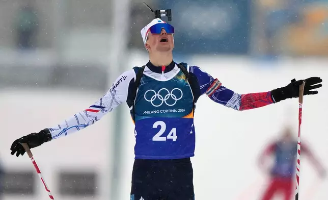 Eric Perrot, of France, reacts as he crosses the finish line to win gold in the men's 4x7.5-kilometer relay biathlon race at the 2026 Winter Olympics in Anterselva, Italy, Tuesday, Feb. 17, 2026. (AP Photo/Mosa'ab Elshamy)