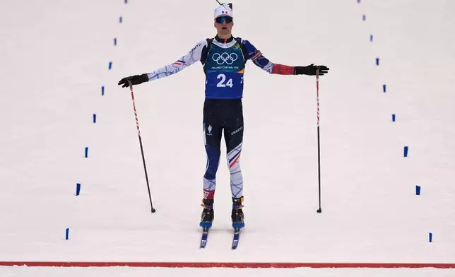 Eric Perrot, of France, skis to the finish line for gold in the men's 4x7.5-kilometer relay biathlon race at the 2026 Winter Olympics in Anterselva, Italy, Tuesday, Feb. 17, 2026. (AP Photo/Andrew Medichini)
