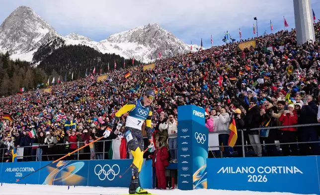 Martin Ponsiluoma, of Sweden, crosses the finish line for gold during the men's 12.5-kilometer pursuit biathlon race at the 2026 Winter Olympics in Anterselva, Italy, Sunday, Feb. 15, 2026. (AP Photo/David J. Phillip)