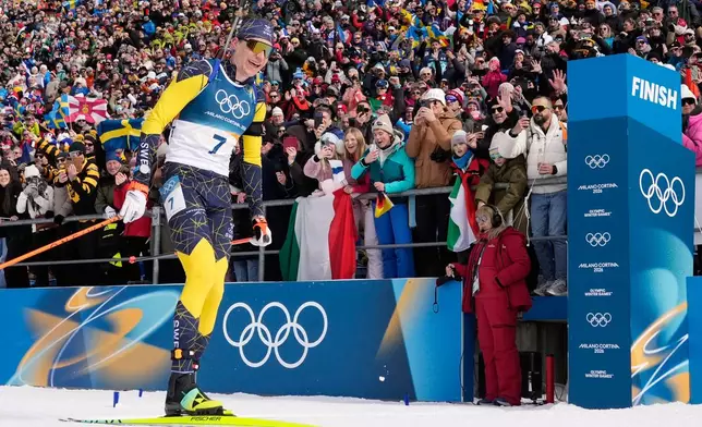 Martin Ponsiluoma, of Sweden, crosses the finish line for gold during the men's 12.5-kilometer pursuit biathlon race at the 2026 Winter Olympics in Anterselva, Italy, Sunday, Feb. 15, 2026. (AP Photo/David J. Phillip)