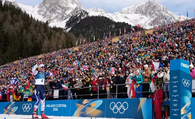 Emilien Jacquelin, of France, crosses the finish line for bronze during the men's 12.5-kilometer pursuit biathlon race at the 2026 Winter Olympics in Anterselva, Italy, Sunday, Feb. 15, 2026. (AP Photo/David J. Phillip)