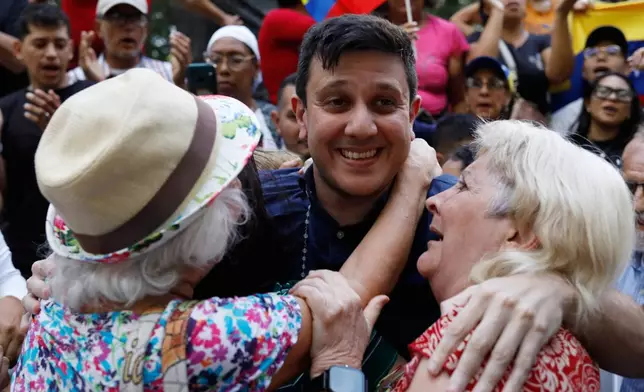 Political activist Jesus Armas is embraced by opposition supporters after his release from prison in Caracas, Venezuela, Sunday, Feb. 8, 2026. (AP Photo/Cristian Hernandez)