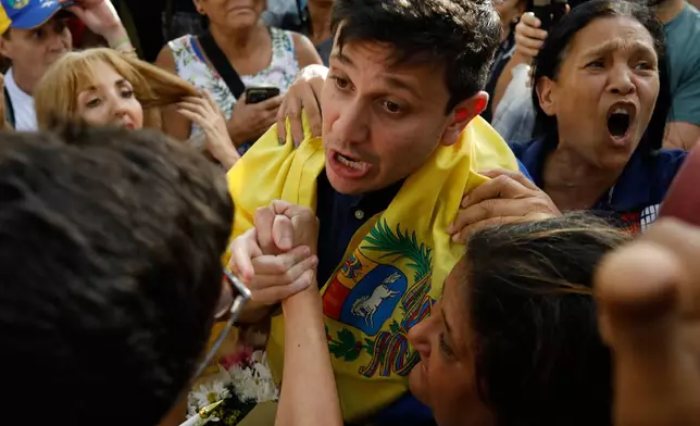 Opposition supporters greet political activist Jesus Armas after his release from prison in Caracas, Venezuela, Sunday, Feb. 8, 2026. (AP Photo/Cristian Hernandez)