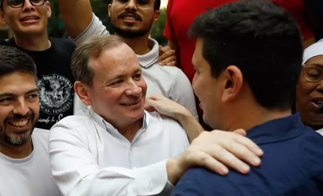 Opposition leader Juan Pablo Guanipa greets political activist Jesus Armas after their release from prison in Caracas, Venezuela, Sunday, Feb. 8, 2026. (AP Photo/Cristian Hernandez)