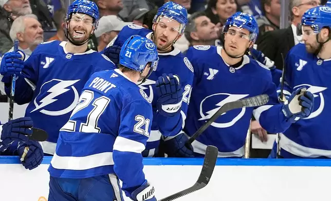 Tampa Bay Lightning center Brayden Point (21) celebrates with the bench after his goal against the Toronto Maple Leafs during the second period of an NHL hockey game Wednesday, Feb. 25, 2026, in Tampa, Fla. (AP Photo/Chris O'Meara)