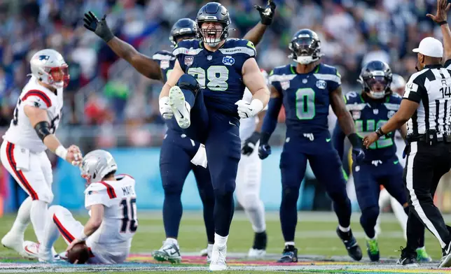 Seattle Seahawks Rylie Mills (98) celebrates after sacking New England Patriots Drake Maye (10) during the second quarter of Super Bowl 60 in Santa Clara, Calif., Sunday, Feb. 8, 2026. (Scott Strazzante/San Francisco Chronicle via AP)