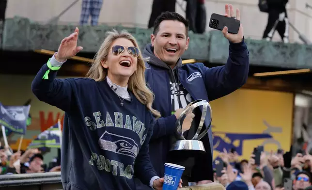Seattle Seahawks head coach Mike MacDonald waves to the crowd during the team's NFL football Super Bowl 60 parade and celebration, Wednesday, Feb. 11, 2026, in Seattle. (AP Photo/John Froschauer)