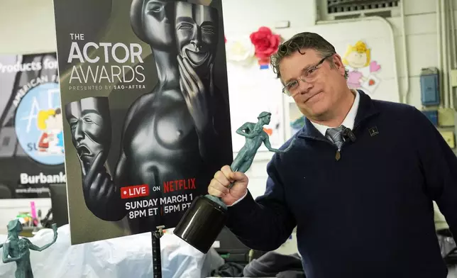 SAG-AFTRA president Sean Astin shows off a finished solid bronze Actor statuette during the 32nd Actor Awards statuette pouring event presented by SAG-AFTRA on Thursday, Feb. 5, 2026, at American Fine Arts Foundry in Burbank, Calif. (AP Photo/Chris Pizzello)