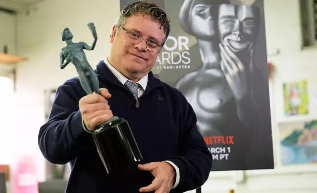 SAG-AFTRA president Sean Astin shows off a finished solid bronze Actor statuette during the 32nd Actor Awards statuette pouring event presented by SAG-AFTRA on Thursday, Feb. 5, 2026, at American Fine Arts Foundry in Burbank, Calif. (AP Photo/Chris Pizzello)