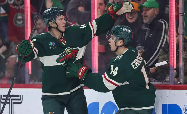 Minnesota Wild center Joel Eriksson Ek, right, celebrates his goal with left wing Matt Boldy (12) during the first period of an NHL hockey game against the Montréal Canadiens, Monday, Feb. 2, 2026, in St. Paul, Minn. (AP Photo/Matt Krohn)