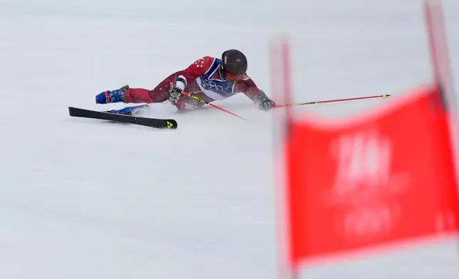 Singapore's Faiz Basha falls during an alpine ski, men's giant slalom race, at the 2026 Winter Olympics, in Bormio, Italy, Saturday, Feb. 14, 2026. (AP Photo/John Locher)
