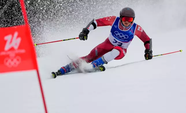 Singapore's Faiz Basha speeds down the course, during an alpine ski, men's giant slalom race, at the 2026 Winter Olympics, in Bormio, Italy, Saturday, Feb. 14, 2026. (AP Photo/John Locher)