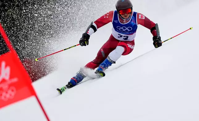 Singapore's Faiz Basha speeds down the course, during an alpine ski, men's giant slalom race, at the 2026 Winter Olympics, in Bormio, Italy, Saturday, Feb. 14, 2026. (AP Photo/John Locher)