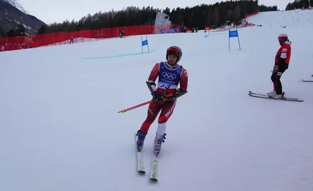 Singapore's Faiz Basha skis down after crashing during an alpine ski, men's giant slalom race, at the 2026 Winter Olympics, in Bormio, Italy, Saturday, Feb. 14, 2026. (AP Photo/Rebecca Blackwell)