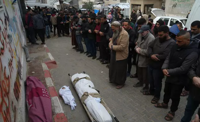 Palestinians mourn over the dead who were killed in an Israeli military strike, at Shifa Hospital in Gaza City, Wednesday, Feb. 4, 2026. (AP Photo/Jehad Alshrafi)