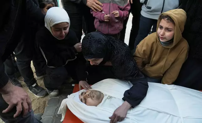 A Palestinian woman and her children bid farewell to their husband and father, Youssef Haboush, who was killed in an Israeli military strike, at Shifa Hospital in Gaza City, Wednesday, Feb. 4, 2026. (AP Photo/Jehad Alshrafi)