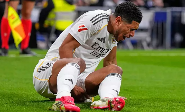 Real Madrid's Jude Bellingham lies on the pitch injured during the Spanish La Liga soccer match between Real Madrid and Rayo Vallecano in Madrid, Spain, Sunday, Feb. 1, 2026. (AP Photo/Manu Fernandez)
