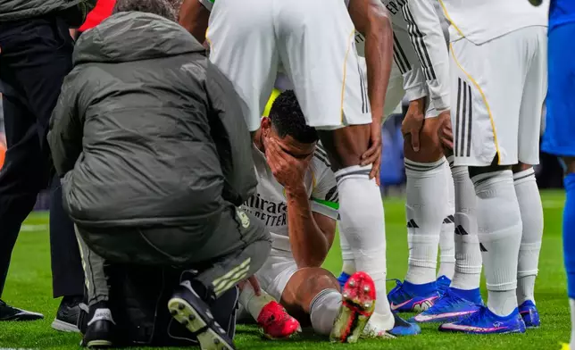 Real Madrid's Jude Bellingham lies on the pitch injured during the Spanish La Liga soccer match between Real Madrid and Rayo Vallecano in Madrid, Spain, Sunday, Feb. 1, 2026. (AP Photo/Manu Fernandez)