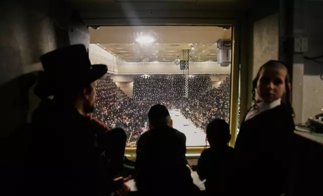 Ultra-Orthodox Jews from the Belz Hasidic dynasty celebrate the Jewish holiday of Tu Bishvat, the "New Year of the Trees," in Jerusalem, Monday, Feb. 2, 2026. (AP Photo/Ohad Zwigenberg)