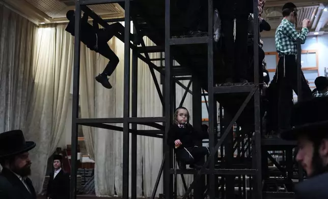 Ultra-Orthodox Jews from the Sanz Hasidic dynasty celebrate the Jewish holiday of Tu Bishvat, the "New Year of the Trees," in Netanya, Israel, Monday, Feb. 2, 2026. (AP Photo/Ariel Schalit)