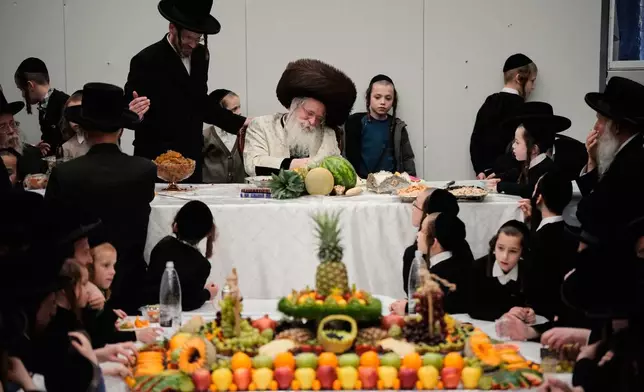 Ultra-Orthodox Jews from the Nadvorna Hasidic dynasty celebrate the Jewish holiday of Tu Bishvat, the "New Year of the Trees," in Jerusalem, Monday, Feb. 2, 2026. (AP Photo/Ohad Zwigenberg)