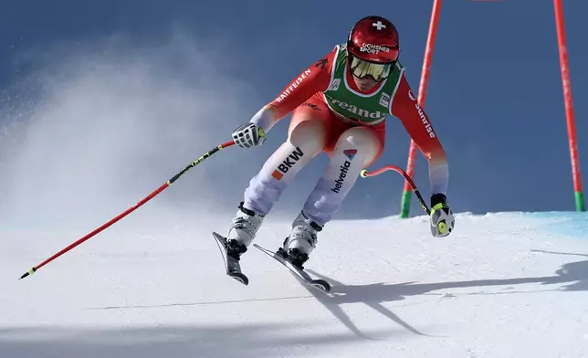 Switzerland's Corinne Suter speeds down the course during an alpine ski, women's World Cup downhill, in Soldeu, Andorra, Friday, February. 27, 2026. (AP Photo/Gabriele Facciotti)