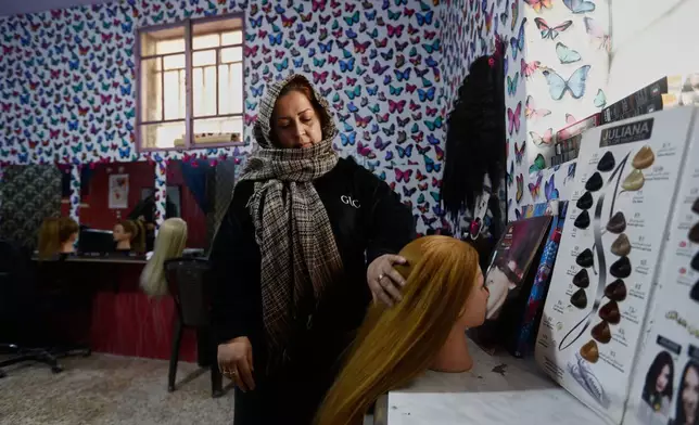 Hairstylist Aliaa al Jafar stands in her studio during an interview in the Kurdish-majority neighborhood of Sheikh Maqsoud, in Aleppo, Syria, Saturday, Feb. 14, 2026. (AP Photo/Omar Sanadiki)
